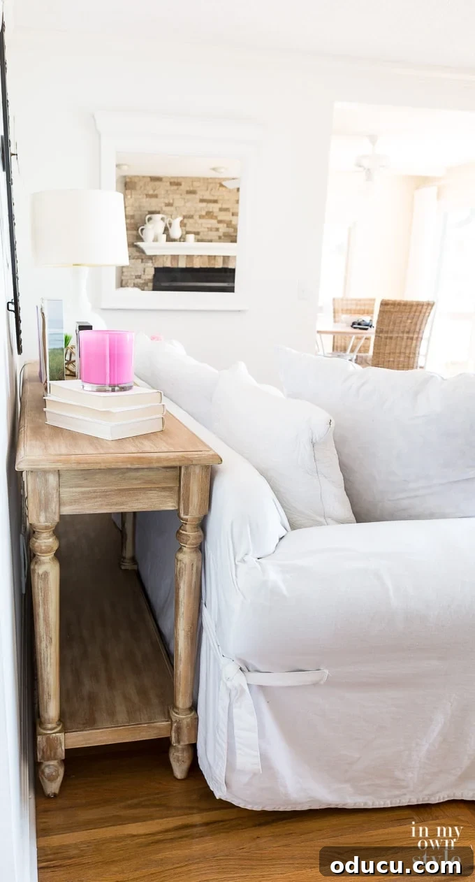Cozy Winter Interiors: Cultivate Calm and Rejuvenation 17 Living room with a sofa pulled away from the wall, featuring a console table behind it