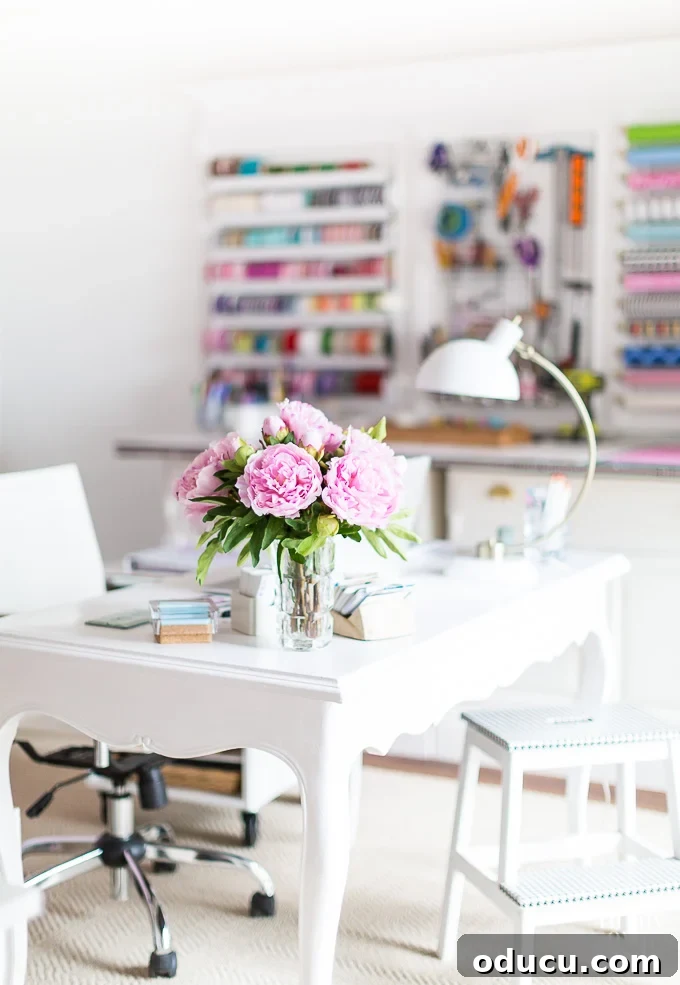 Cozy Winter Interiors: Cultivate Calm and Rejuvenation 21 Craft room with a white desk and a vase of fresh peonies, adding a pop of color