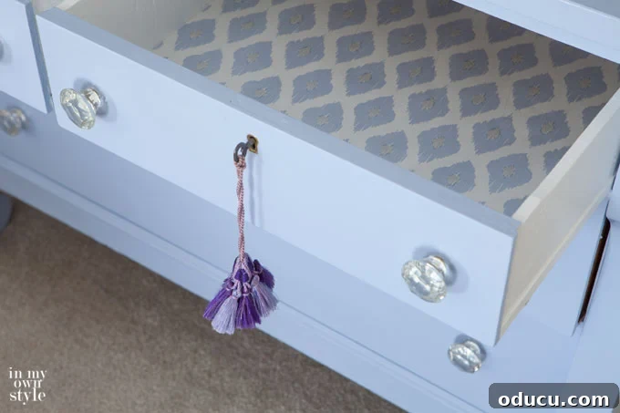 Cozy Winter Interiors: Cultivate Calm and Rejuvenation 22 Lined dresser drawer with blue and white patterned gift wrap for a hidden pop of color