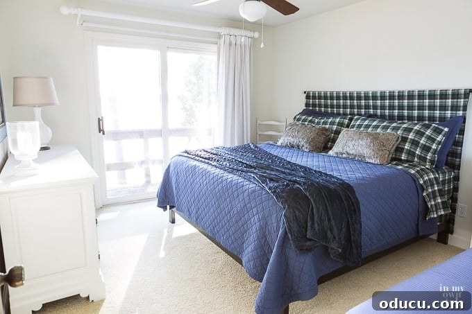 Easy DIY Headboard for Your Guest Space 9 Bed pushed against the wall with the newly installed sheet headboard in a finished guest room
