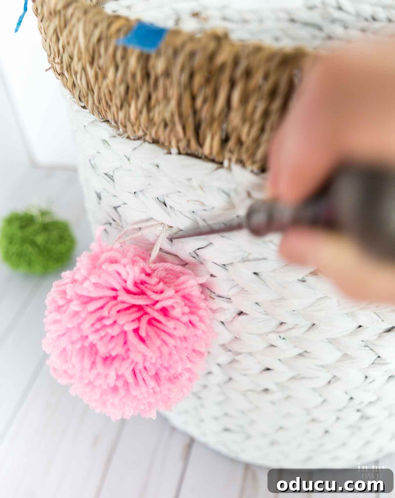 My Signature Pom Pom Basket 12 Preparing to attach pom poms to a woven basket