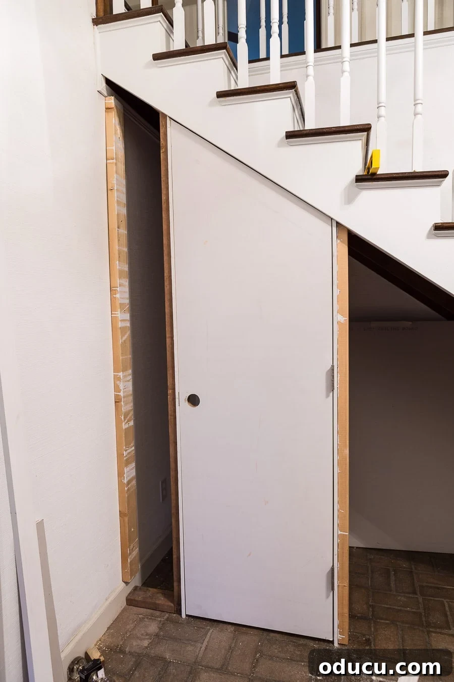 Transform Your Staircase into a Secret Storage Haven 12 How to DIY a hidden door affordably, showing the door's lower section raised for an uneven floor.