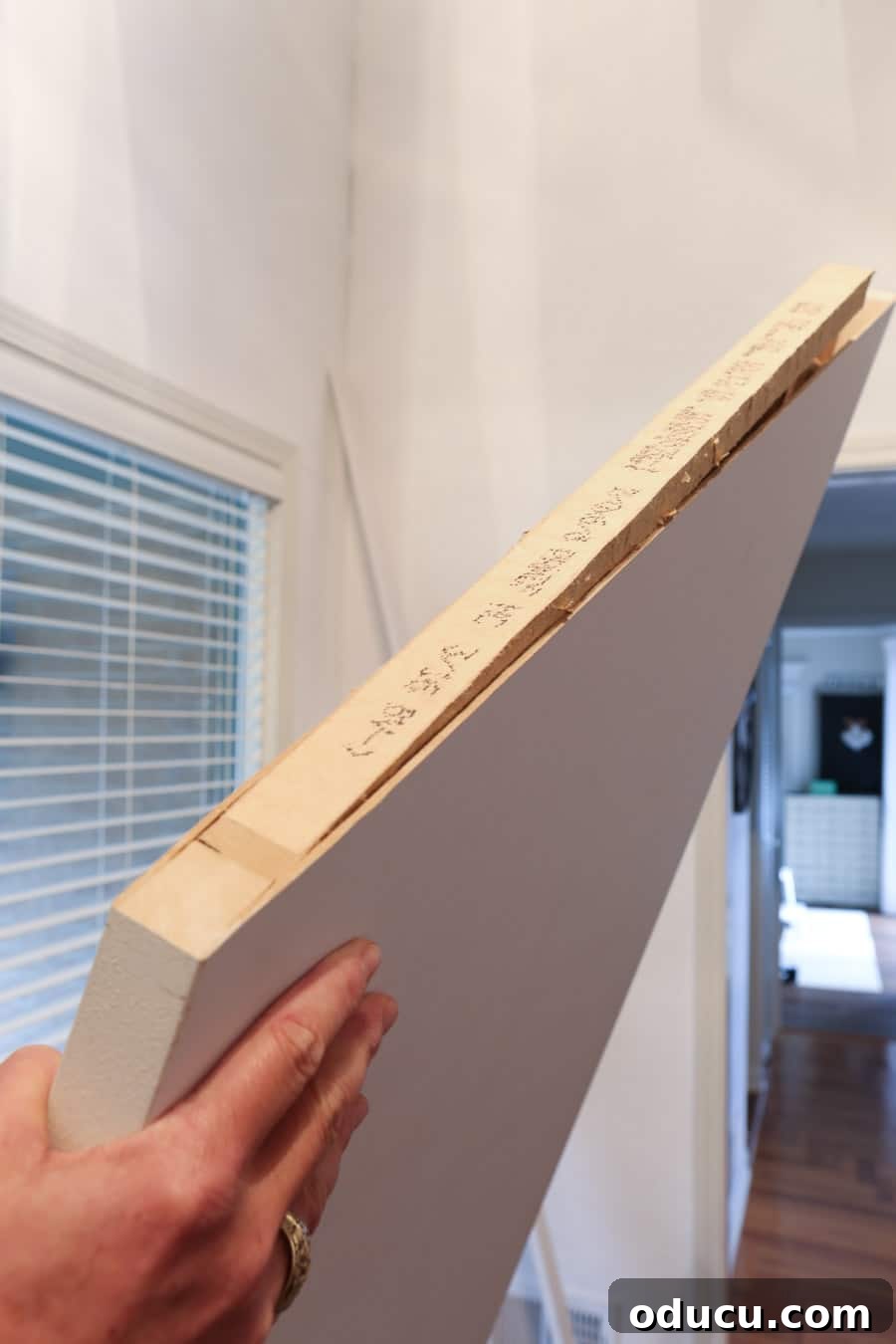 Transform Your Staircase into a Secret Storage Haven 14 How to make a door for an under the staircase closet, showing the angled cut on top of the door.