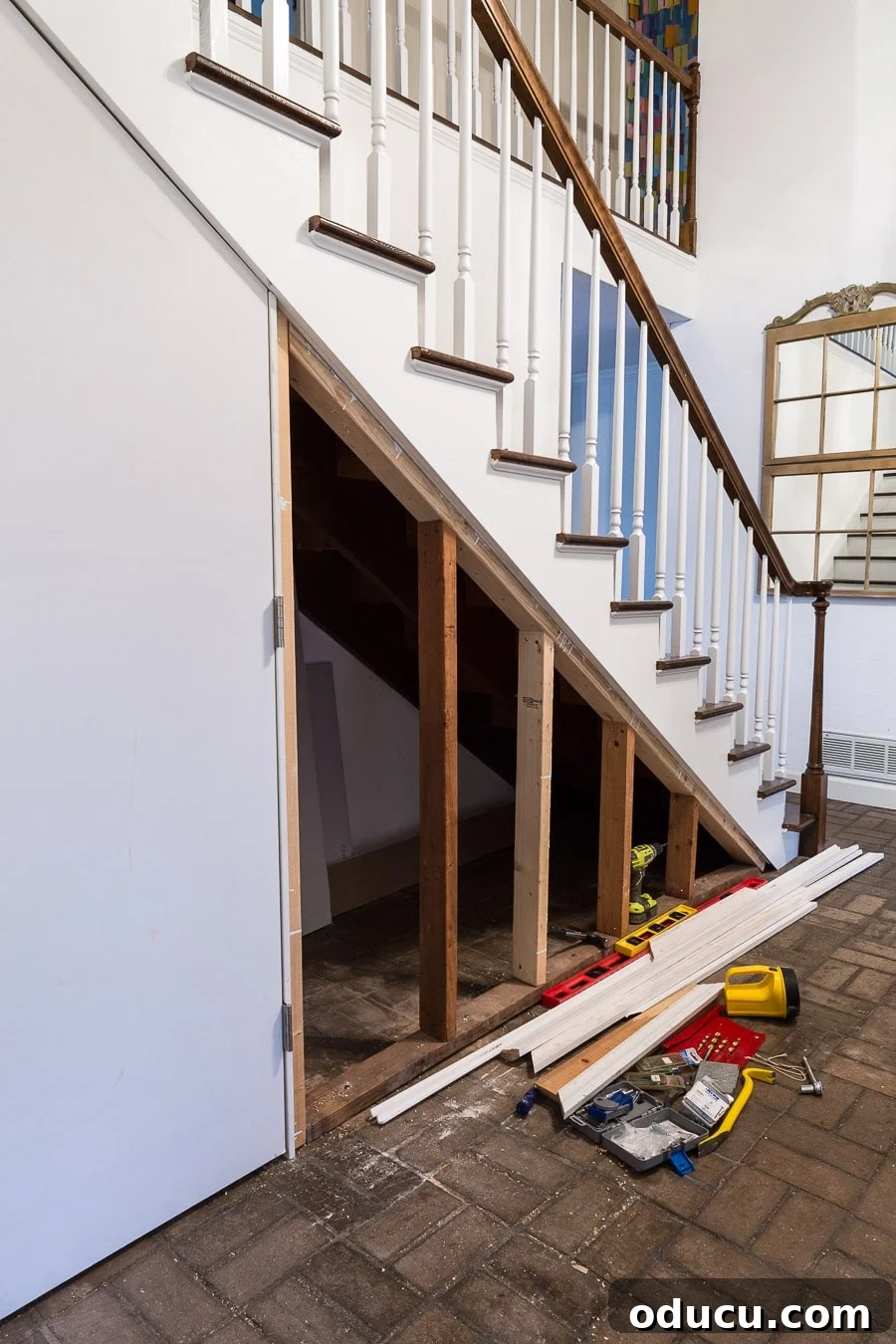 Transform Your Staircase into a Secret Storage Haven 17 Tutorial showing how to DIY a closet under a staircase with a hidden door, highlighting the framing process.