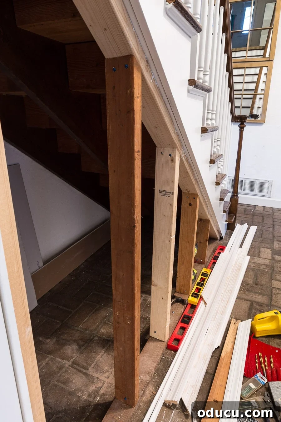 Transform Your Staircase into a Secret Storage Haven 18 DIY under a staircase closet, showing the gap left for sheetrock and batten boards.