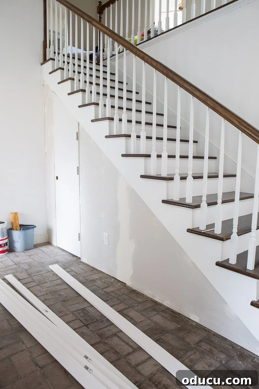 Transform Your Staircase into a Secret Storage Haven 19 Add sheetrock to under stairs framing, illustrating the installed drywall.