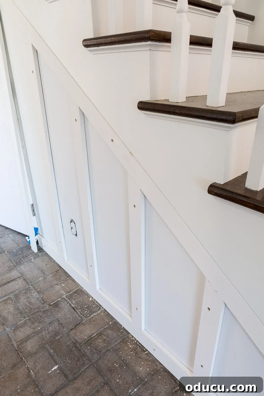 Transform Your Staircase into a Secret Storage Haven 21 Adding a hidden door and closet under a staircase, with the board and batten framework taking shape.