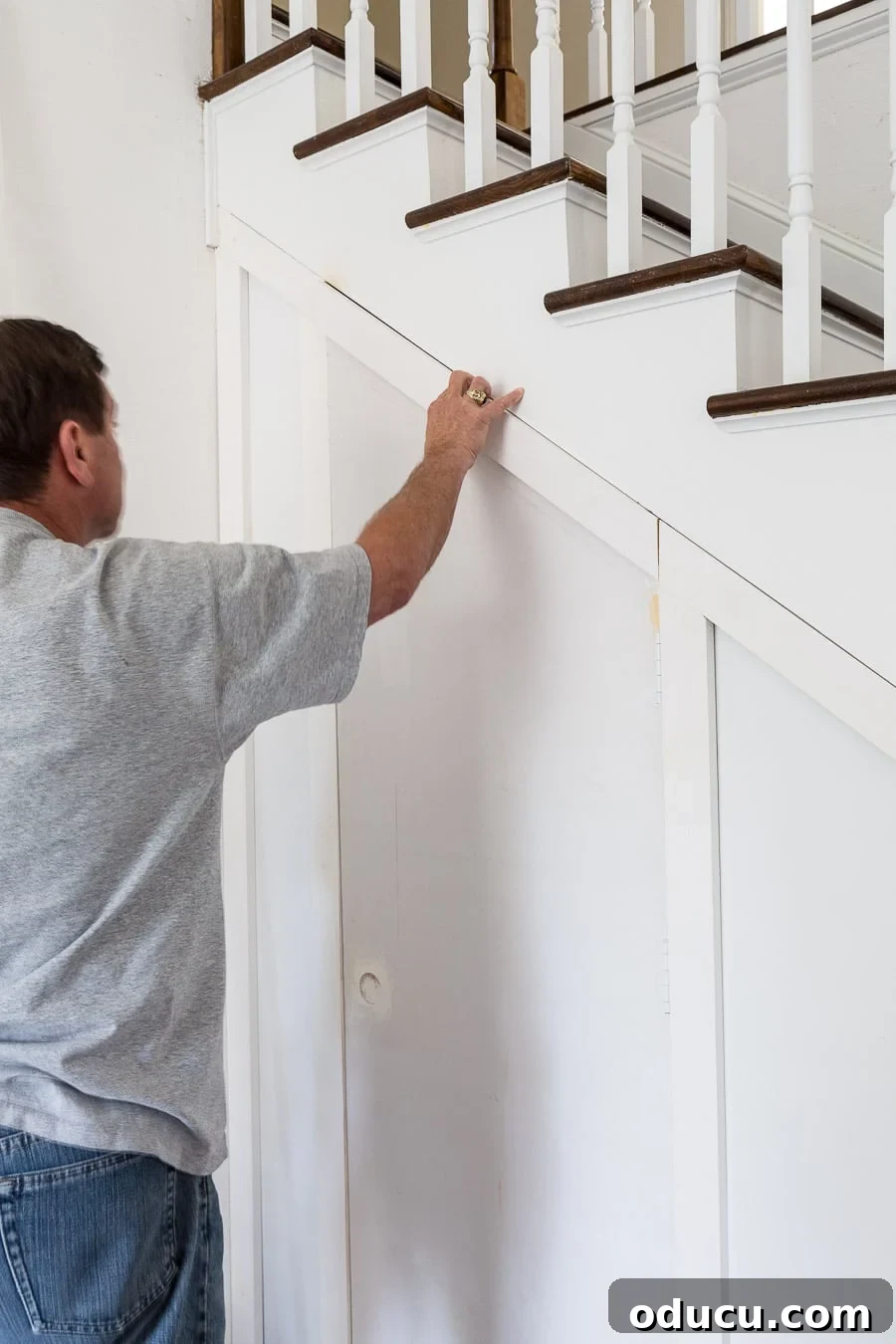 Transform Your Staircase into a Secret Storage Haven 23 Under a staircase hidden storage, showing the batten board centered on the hidden door.