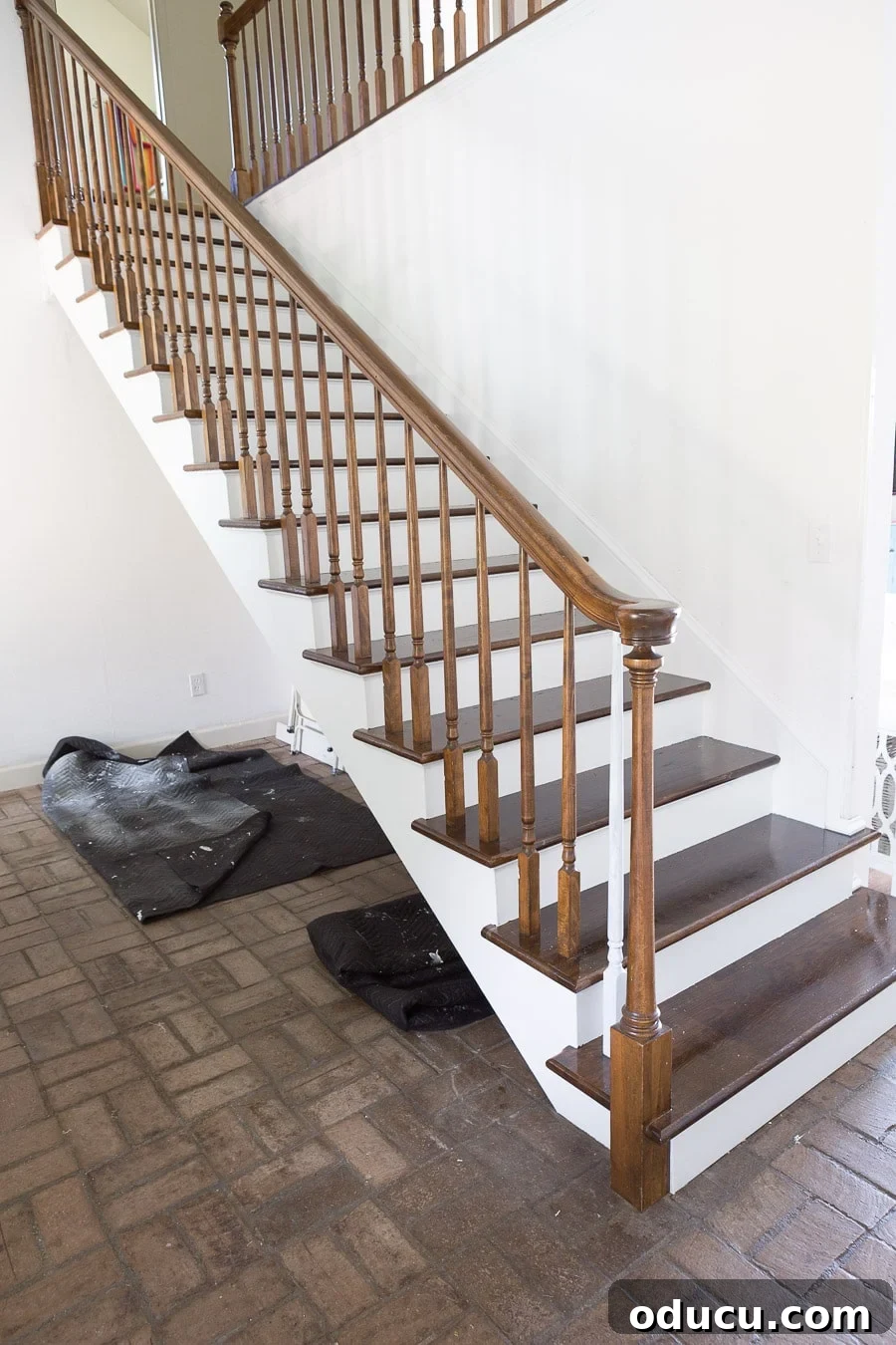 Transform Your Staircase into a Secret Storage Haven 4 How to add a hidden door under a staircase to maximize storage in the foyer.