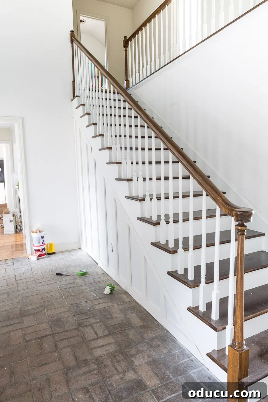 Transform Your Staircase into a Secret Storage Haven 31 DIY under a staircase closet with hidden door, showing the completed and painted space.