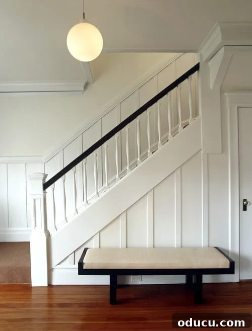 Transform Your Staircase into a Secret Storage Haven 6 Storage under staircase idea, featuring a board and batten design for a hidden door.