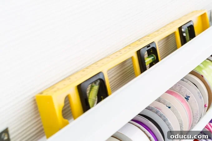 Conquer Ribbon Chaos: Genius Storage for Every Spool 14 Using a bubble level to ensure straight ribbon shelves