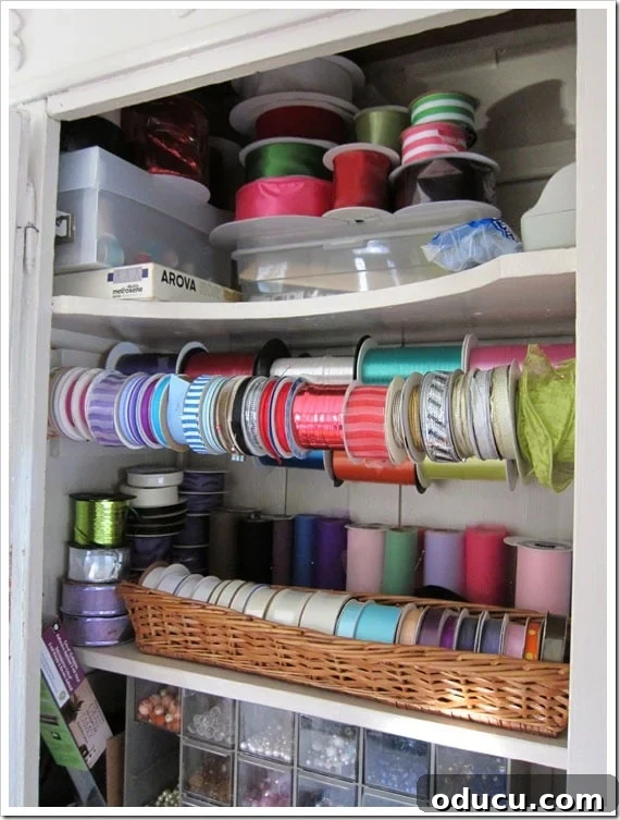 Conquer Ribbon Chaos: Genius Storage for Every Spool 22 Organizing spools of ribbon with tension rods in a cabinet