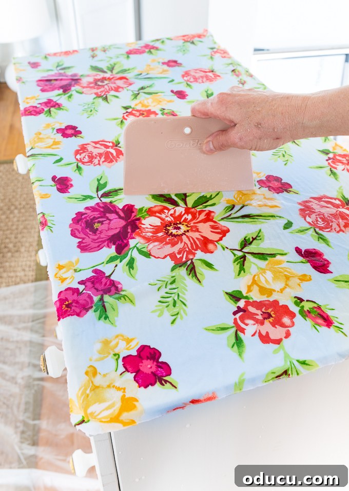 Revitalize Furniture with Fabric and Liquid Starch 11 How to attach fabric to furniture using liquid starch: Applying saturated fabric and smoothing out bubbles.