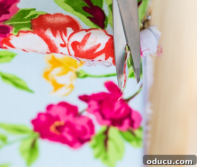 Revitalize Furniture with Fabric and Liquid Starch 13 Furniture makeover tips using fabric and liquid starch: Cutting excess fabric from corners.