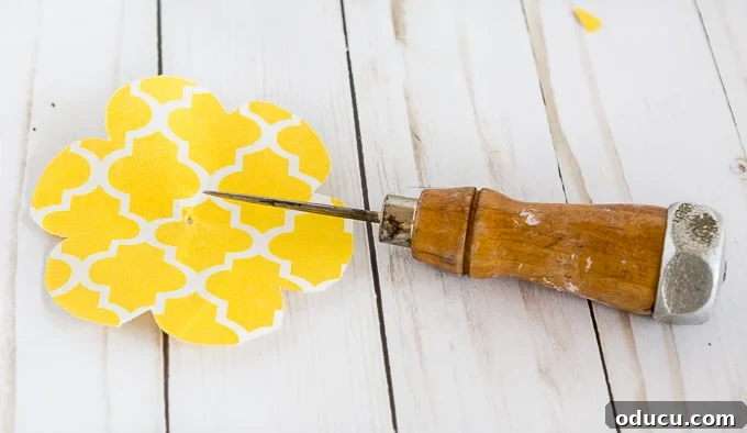 Revitalize Furniture with Fabric and Liquid Starch 25 Creative ideas for drawer pulls and knobs: Creating a screw hole in the assembled fabric flower.
