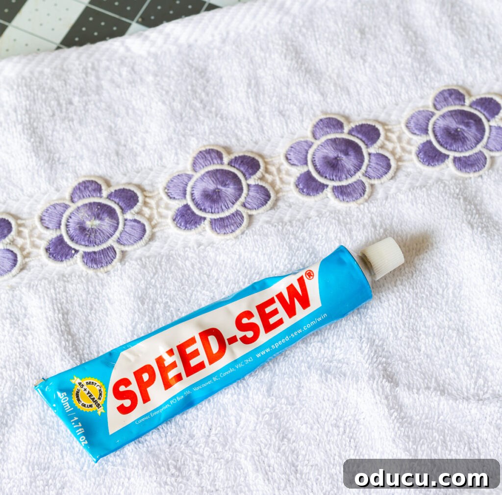 Elevate Your Bathroom With Towel Decor 13 A stylish close-up showcasing a no-sew bathroom towel trim technique, highlighting the ease and beauty of adhesive-based embellishments.