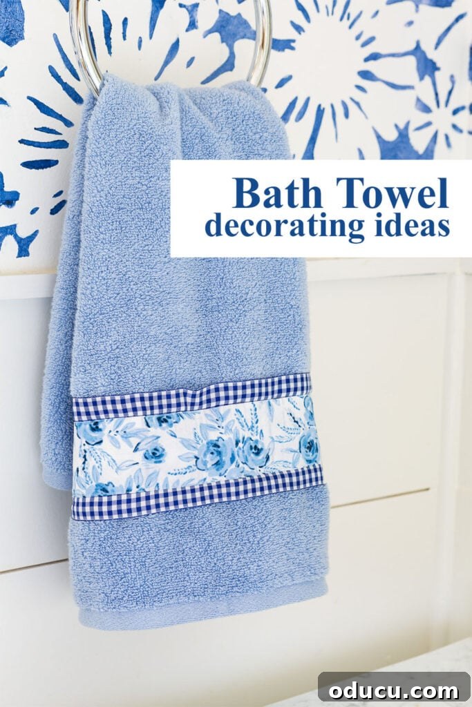 Elevate Your Bathroom With Towel Decor 23 A vibrant blue and white hand towel with text overlay reading 'Bath towel decorating ideas.' The image is designed to inspire readers to turn plain towels into stylish bathroom features using ribbon, fabric, and buttons.