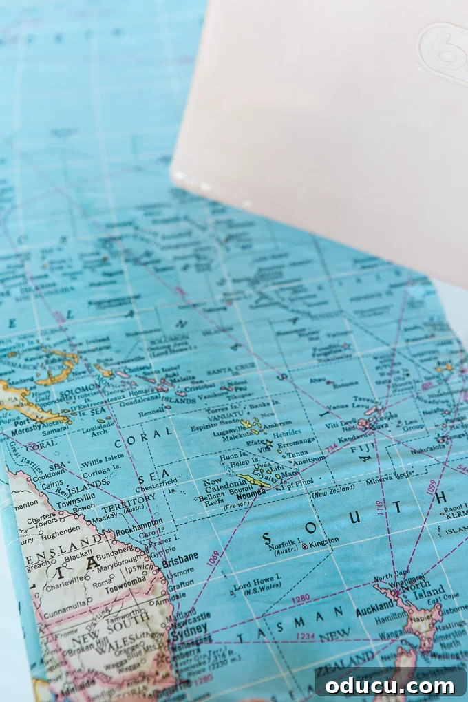Globetrotting Laundry Room: DIY Map Wallpaper Project 18 DIY map wallpaper step by step tutorial that shows how to remove wrinkles that may appear when applying maps and or paper to walls