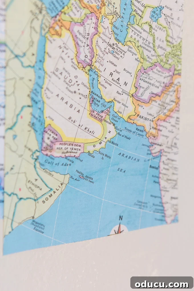 Globetrotting Laundry Room: DIY Map Wallpaper Project 23 DIY map wallpaper step by step tutorial that shows how to remove wrinkles that may appear when applying maps and or paper to walls