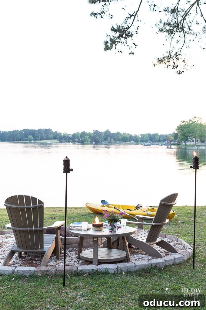 My Lakeside Haven 2 TIKI Tabletop Firepiece with Clean Burn System on a table by the lake, creating a warm and inviting ambiance for outdoor dining.
