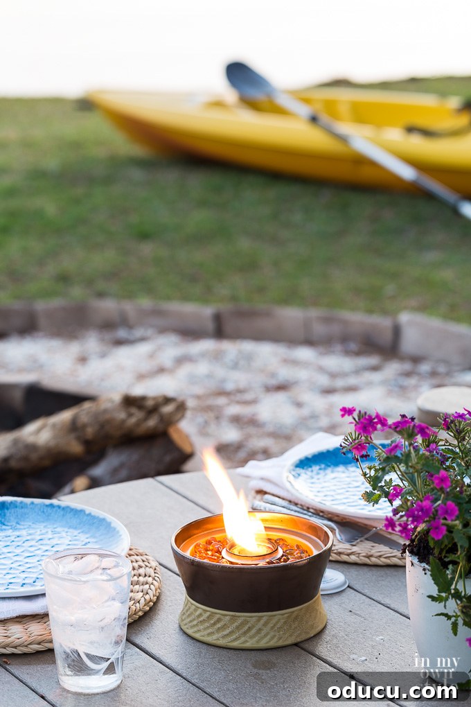 My Lakeside Haven 11 The Clean Burn Tabletop Firepiece in Bronze Ceramic, adorned with decorative stones, creating a tranquil and Zen-like ambiance for outdoor spaces.