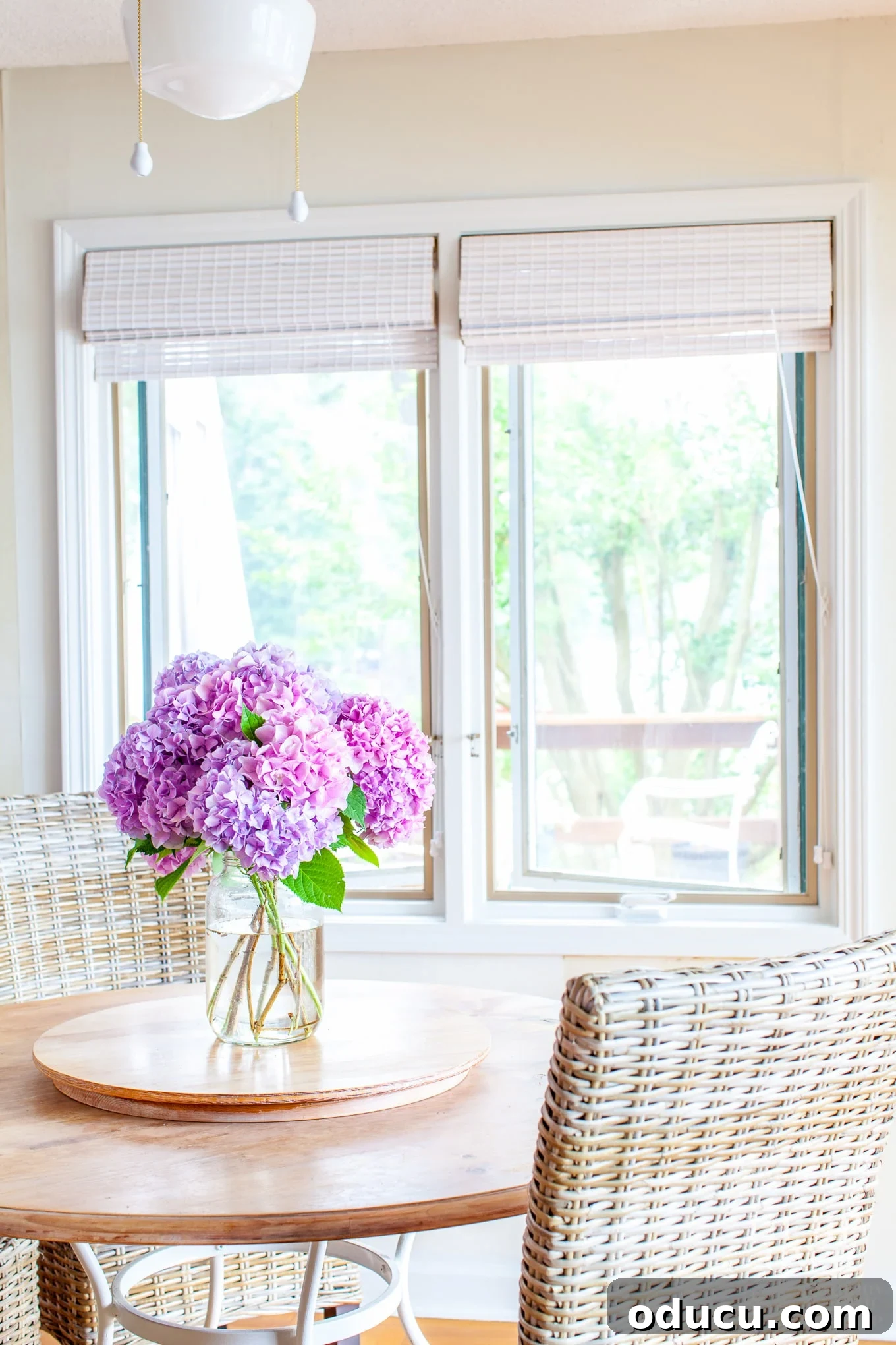 Beautiful Flower Arrangements Made Simple 7 Freshly cut pink hydrangeas from the garden arranged simply in a large jar on a kitchen table.