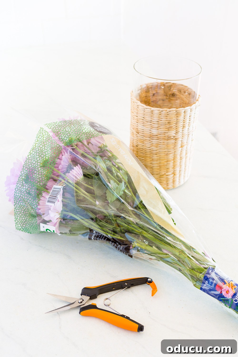 Beautiful Flower Arrangements Made Simple 10 A collection of flower arranging tools including snips, a vase, and fresh flowers.