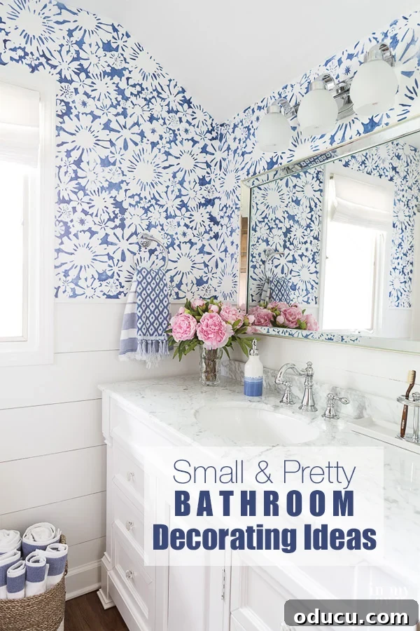 Blue and White small bathroom with stenciled walls and white vanity.