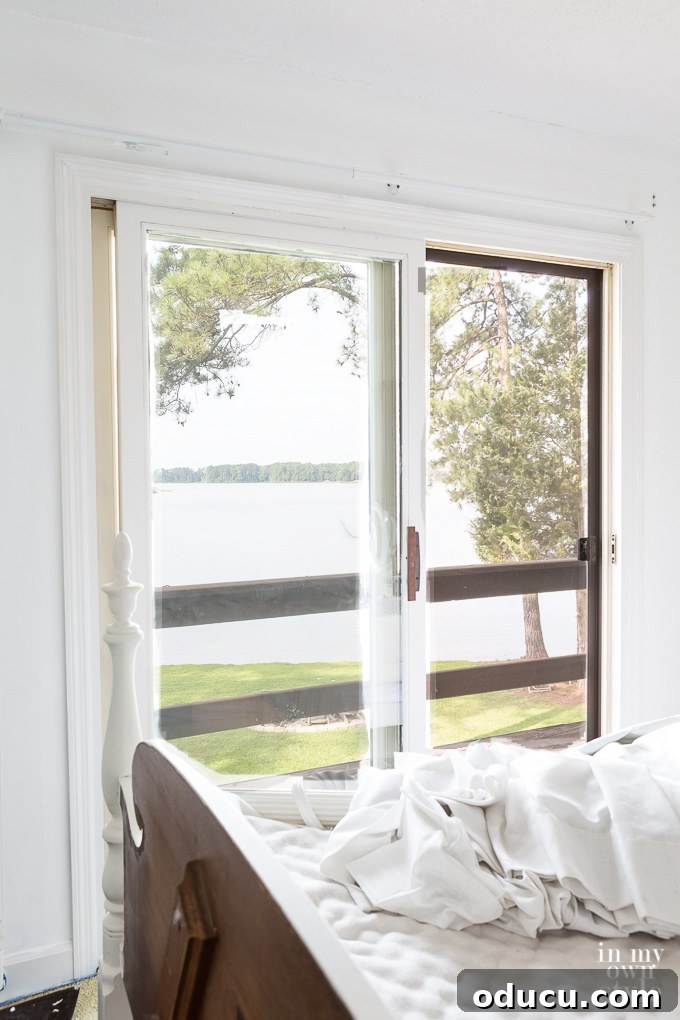 Guest Room Revamp in Motion 2 Guest room with a newly installed ceiling fan offering a refreshing breeze and serene views of the lake