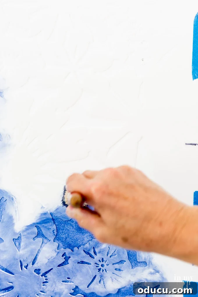 Achieve the Faux Wallpaper Look with Paint and Stencils 12 Applying stencil paint to a wall with a pouncing motion for even coverage