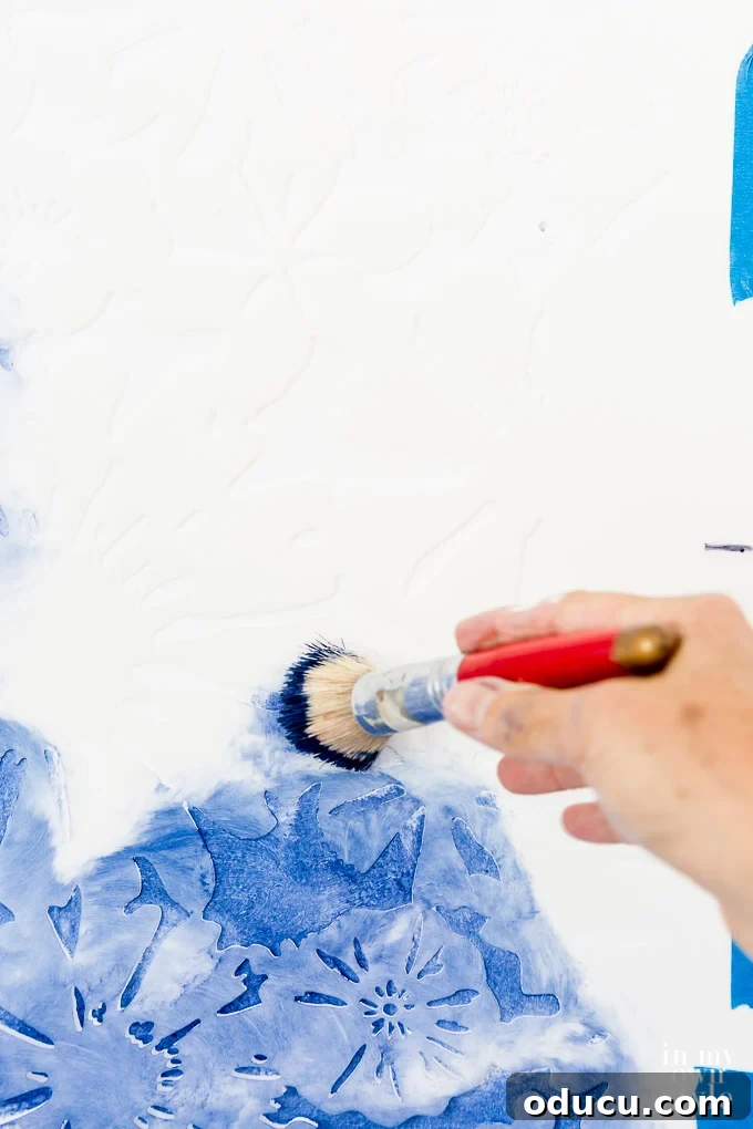 Achieve the Faux Wallpaper Look with Paint and Stencils 13 Using a stencil brush to apply paint to a wall stencil with precision