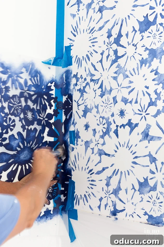 Achieve the Faux Wallpaper Look with Paint and Stencils 19 Final touches to wall stenciling in a corner using a brush