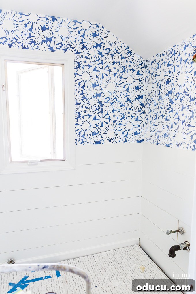 Achieve the Faux Wallpaper Look with Paint and Stencils 20 Progress of wall stenciling tutorial, showing completed sections of faux wallpaper