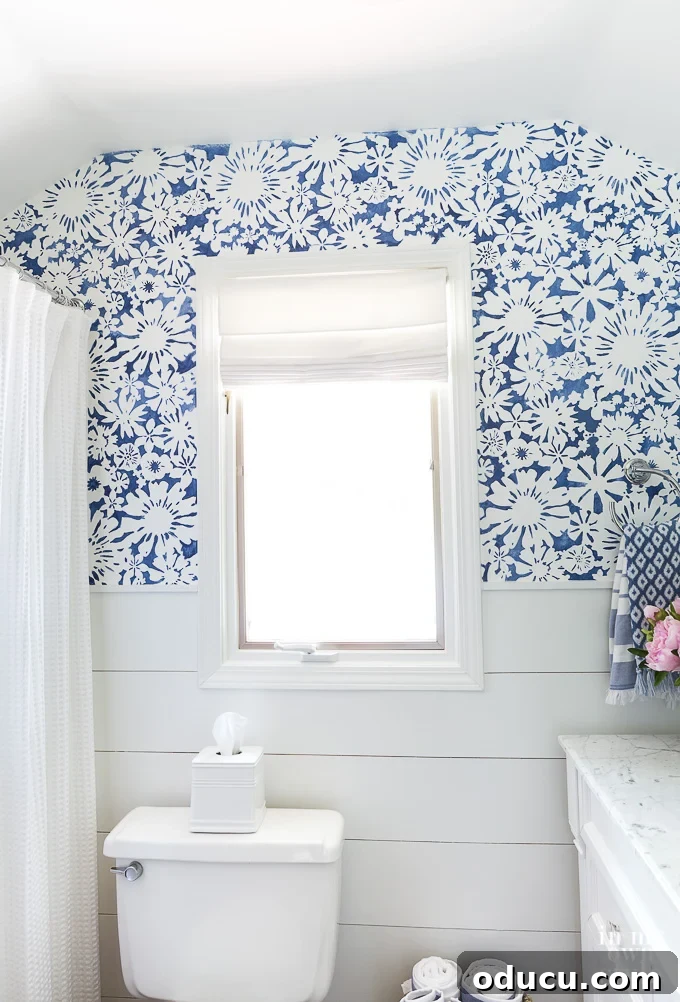 Achieve the Faux Wallpaper Look with Paint and Stencils 4 Stenciling walls in a small bathroom with an angled ceiling, showcasing the DIY process