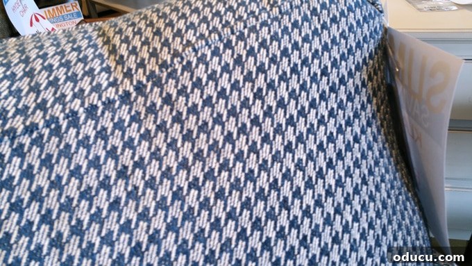 Wanderlust and Wardrobes 4 Close-up of elegant blue and white houndstooth upholstery fabric, ideal for stylish home furniture and interior accents.