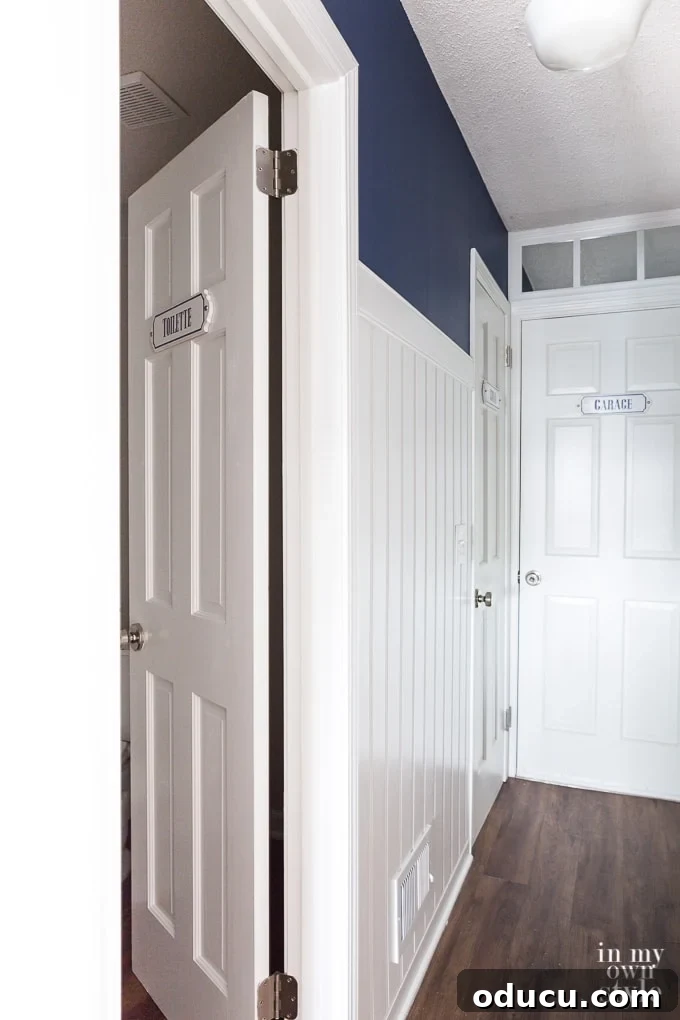 Chic French Inspired Door Plaques 9 Beadboard paneling in a decorated hallway
