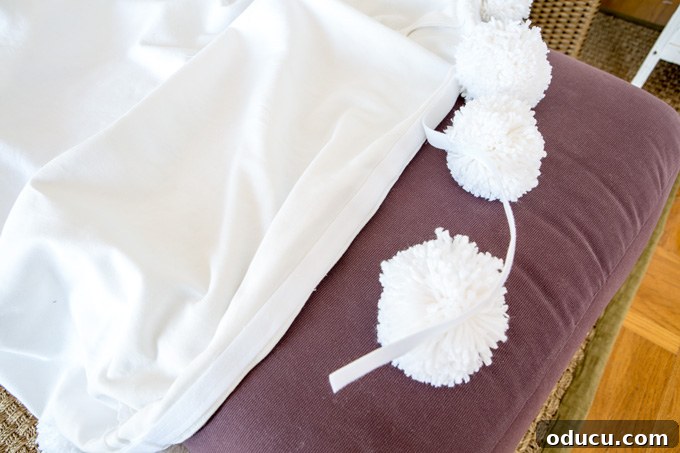 Stylish Ottoman Slipcover with Detachable Pom Pom Accent 22 Innovative Pom-pom-trim-DIY that is removable from slipcover for easy care