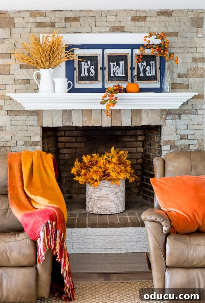 Recliner Chic: Elevating Your Living Room's Style 13 Fall leaves in basket placed in an unused fireplace flanked by 2 leather recliner chairs.