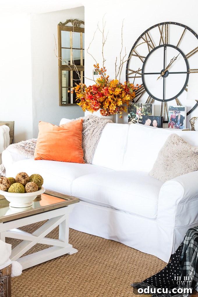 Effortless Autumn Centerpiece 3 Close-up of an easy fall floral arrangement, showcasing faux leaves, berries, and hydrangeas, ideal for sofa table decor