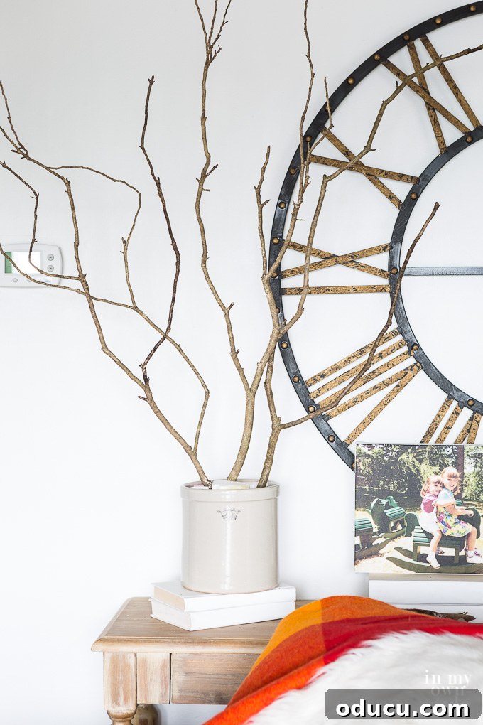 Effortless Autumn Centerpiece 6 Starting the autumn floral arrangement by inserting natural branches into foam inside a white-painted crock