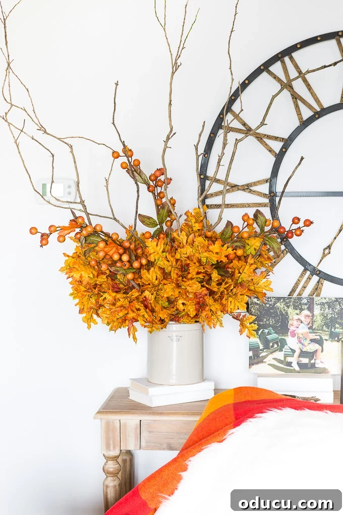 Effortless Autumn Centerpiece 9 Three faux persimmon berry stems are added to the fall arrangement, gracefully draped to mimic natural growth