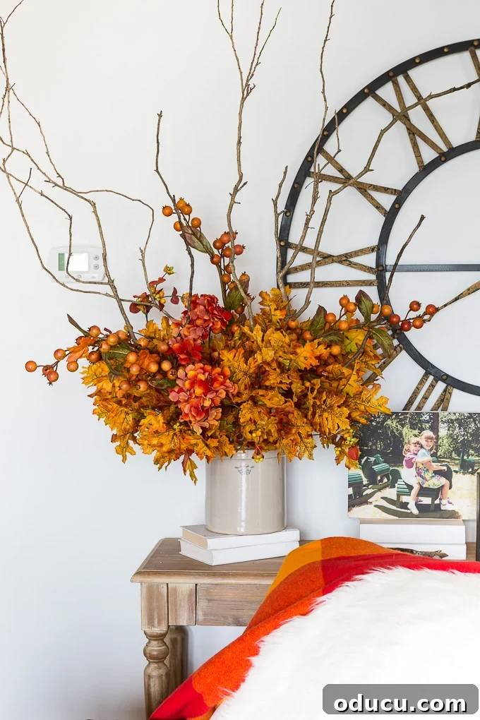 Effortless Autumn Centerpiece 10 The next step in the DIY fall arrangement: adding faux hydrangeas for fullness and a soft texture