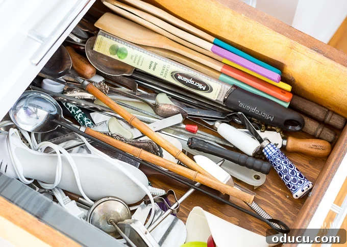 Before shot of a kitchen utensil junk drawer kitchen drawer organizing tips