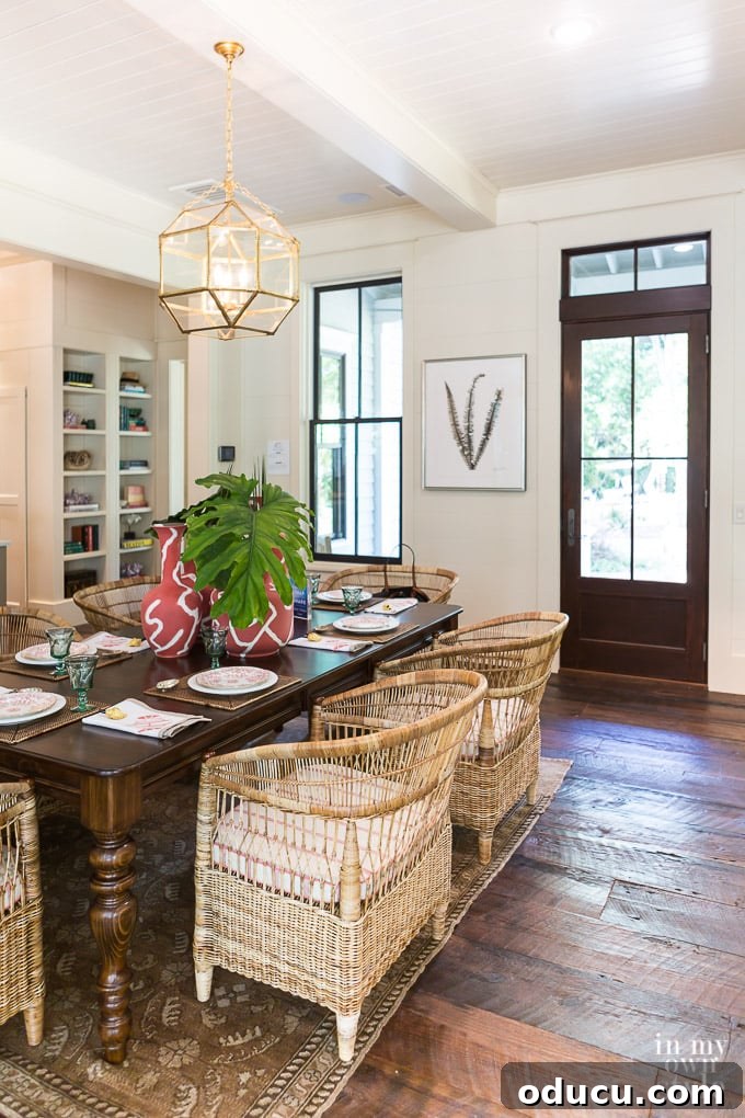 Design Dreams Unveiled at the Southern Living Idea House 17 Living room decor with vibrant coral and refreshing green accents, complementing neutral tones and reclaimed wood floors