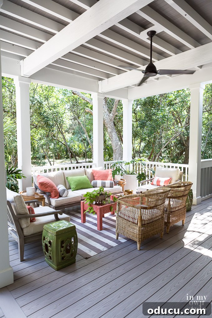 Design Dreams Unveiled at the Southern Living Idea House 20 Outdoor porch decorated with a refreshing coral and green color scheme, perfect for coastal living