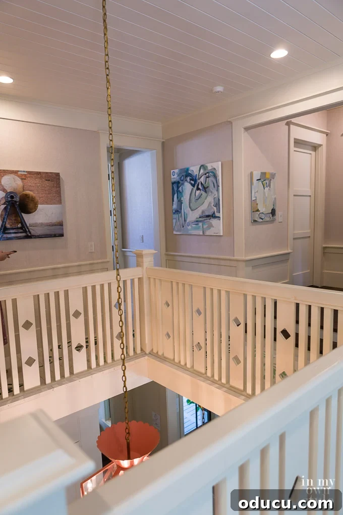 Design Dreams Unveiled at the Southern Living Idea House 27 Second floor landing at the Southern Living Idea House, overlooking the kitchen below through an architectural opening