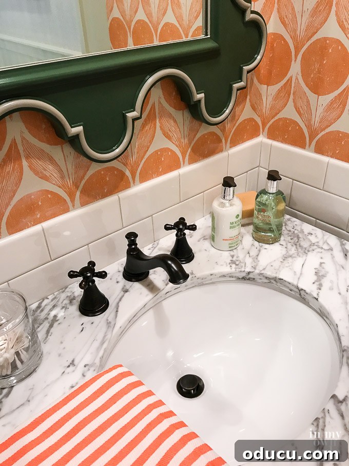 Design Dreams Unveiled at the Southern Living Idea House 34 Vibrant coral and green bathroom decor, showcasing bold color and pattern use in the Idea House