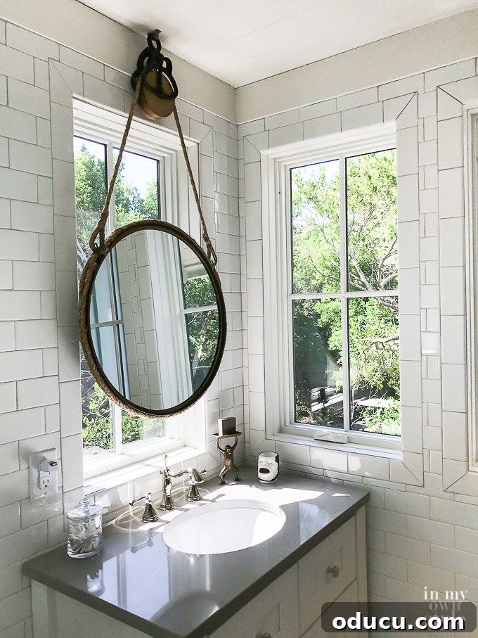 Design Dreams Unveiled at the Southern Living Idea House 39 The Crofter bath at the Southern Living Idea House featuring a unique rope-hung mirror and Delta Faucet