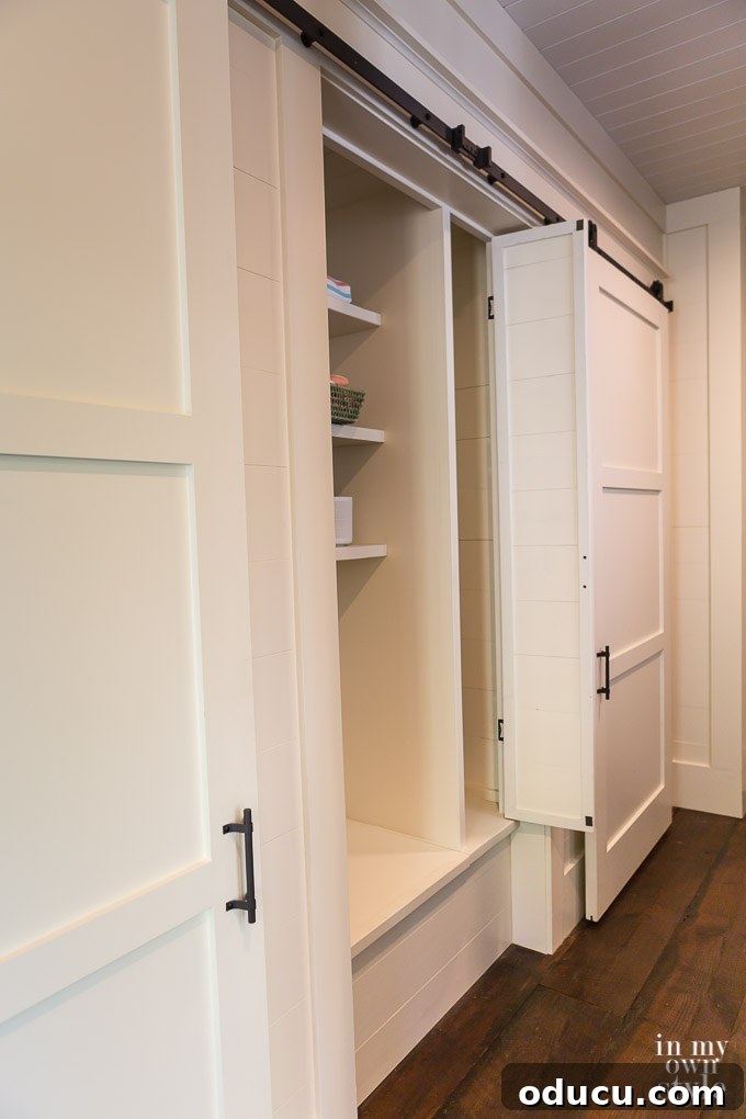 Design Dreams Unveiled at the Southern Living Idea House 41 Open rolling door closet in the hallway of the Southern Living Idea House 2017, showcasing ample storage
